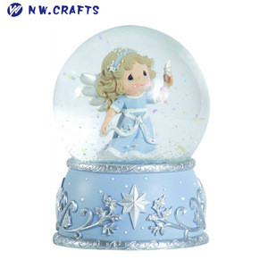 angel holding a star snow globe baptism baby shower souvenirs